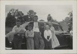 Donnie,George,Marilyn and two more girls and a boy standing beside a car