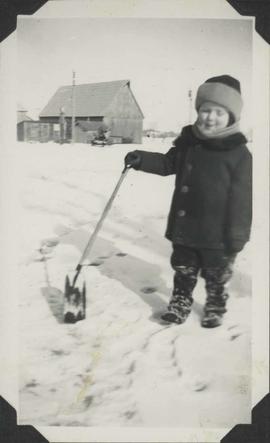 Young George Burns shovelling snow