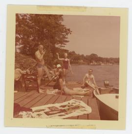 Five people on a dock