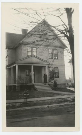 Woman standing on front stairs of house in Lansdowne