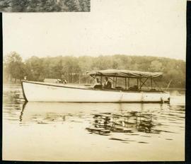 Two people in boat with Bimini top