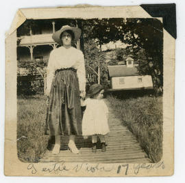 Woman and toddler, inscribed “Gertie, Viola, 17 years” hotel and stable in background