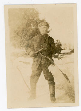 Del Wood holding an ice saw.