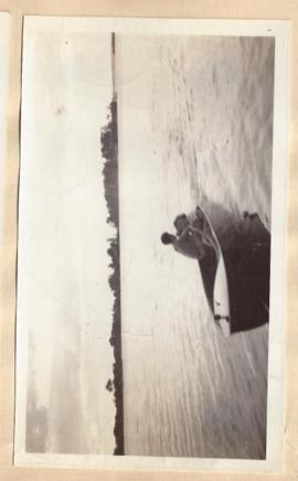 1 photograph of man in boat