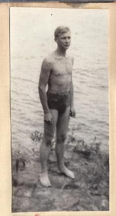 Guest book-man in bathing trunks standing by water