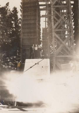 Three people on structure