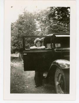 Photograph of woman, Vivian with a car