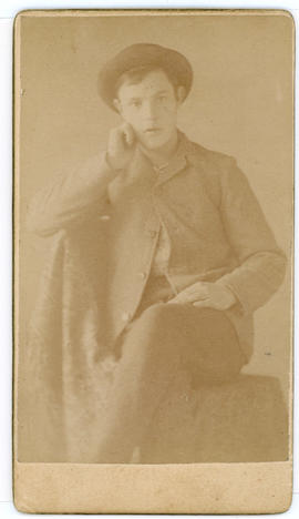 Young man with hat sitting